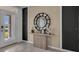 Bright entryway with modern console table, round mirror, and front door view at 2809 Jamaica Way, Haines City, FL 33844