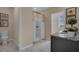 Bright bathroom showcasing a walk-in shower, a toilet, and granite countertops at 2813 Jamaica Way, Haines City, FL 33844