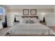 A neutral bedroom features a large bed with decorative pillows and coordinating bedside tables with lamps at 2813 Jamaica Way, Haines City, FL 33844