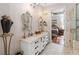 Bathroom featuring double sinks, decorative mirrors, elegant lighting, and tiled shower at 2865 Eastham Ln, Kissimmee, FL 34741