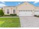 Charming single-story home featuring a tile roof, brick driveway, and well-manicured lawn at 2865 Eastham Ln, Kissimmee, FL 34741