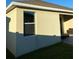 Back exterior of home features a window and a covered patio with outdoor seating at 3016 Madelia Ln, Kissimmee, FL 34744