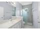 Bright bathroom featuring walk-in shower, vanity, sink, and large mirror at 3575 Victoria Pines Dr # 276, Orlando, FL 32829