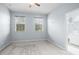 Light-filled bedroom featuring neutral walls, plush carpeting, and two windows at 3575 Victoria Pines Dr # 276, Orlando, FL 32829