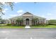 Well-manicured, single-story clubhouse with double-door entrance, palm trees and abundant landscaping at 3575 Victoria Pines Dr # 276, Orlando, FL 32829