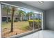 Screened patio offers a view of the backyard with lush landscaping and surrounding palm trees at 3575 Victoria Pines Dr # 276, Orlando, FL 32829