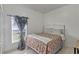 A quaint bedroom with floral bedding and blue patterned drapes at 372 Aylesbury Ct, Kissimmee, FL 34758