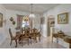 Elegant dining room area showcasing beautiful chairs and natural light from a large window at 372 Aylesbury Ct, Kissimmee, FL 34758