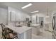 Bright kitchen featuring white cabinets, stainless steel appliances, and a breakfast bar at 372 Aylesbury Ct, Kissimmee, FL 34758