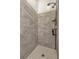 Tiled shower with hexagonal tile flooring, built-in shelving with shower products, and a multi-setting shower head at 372 Aylesbury Ct, Kissimmee, FL 34758