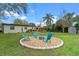 Backyard featuring green grass, a deck and a fire pit area with Adirondack chairs at 4216 Kildaire Ave, Orlando, FL 32812