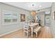 Bright dining room with wood floors and a decorative light fixture above the table at 4216 Kildaire Ave, Orlando, FL 32812