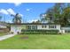 Charming single-story home with manicured lawn, blue door and lush landscaping at 4216 Kildaire Ave, Orlando, FL 32812