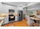 Contemporary kitchen featuring stainless appliances, light cabinets, and a dining area at 4216 Kildaire Ave, Orlando, FL 32812