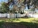 Fenced backyard with two storage sheds and large trees at 423 Ololu Dr, Winter Park, FL 32789