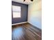 Bedroom featuring updated flooring and a window with mini blinds at 423 Ololu Dr, Winter Park, FL 32789