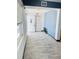 A bright entryway features wood-look tile flooring, fresh paint and modern light fixture at 423 Ololu Dr, Winter Park, FL 32789