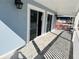 Outdoor porch area with a white railing and sliding glass doors to the interior at 423 Ololu Dr, Winter Park, FL 32789