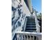 Exterior view of light blue home, shows staircase with light colored wooden steps at 423 Ololu Dr, Winter Park, FL 32789