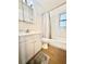 Bright bathroom featuring a shower/tub combo with white tile and a vanity with storage at 430 Pennsylvania Ave, Winter Garden, FL 34787