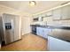 Modern kitchen with stainless steel appliances, white subway tile backsplash, and wood-look floors at 430 Pennsylvania Ave, Winter Garden, FL 34787