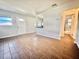 This empty living room features tile floors and a breakfast bar pass through to kitchen at 430 Pennsylvania Ave, Winter Garden, FL 34787