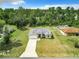 Aerial shot of a home with a long driveway, a well-kept lawn, and surrounding trees at 4790 Sw 166Th Loop, Ocala, FL 34473