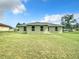 Spacious green backyard showcasing the home's exterior and well-kept lawn at 4790 Sw 166Th Loop, Ocala, FL 34473