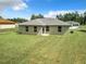 Expansive backyard featuring a well-maintained lawn and the rear of a single-story home at 4790 Sw 166Th Loop, Ocala, FL 34473