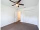 Comfortable bedroom featuring neutral carpet flooring, closet, ceiling fan and ensuite access at 4790 Sw 166Th Loop, Ocala, FL 34473