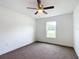 Bright bedroom showcasing a window offering natural light and neutral carpet flooring at 4790 Sw 166Th Loop, Ocala, FL 34473