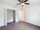 Bedroom with ceiling fan and a closet with shelving at 4790 Sw 166Th Loop, Ocala, FL 34473