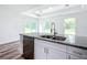 Stylish kitchen island features stainless dishwasher and granite countertops at 4790 Sw 166Th Loop, Ocala, FL 34473