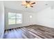 Living room with wood-look floors, ceiling fan, and bright window at 4790 Sw 166Th Loop, Ocala, FL 34473