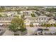 This aerial view features a well-maintained residential neighborhood with colorful townhouses and lush greenery at 4820 Battaglia Blvd, St Cloud, FL 34769