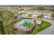 Aerial view of community pool with picnic tables, lounge chairs, parking, and manicured landscaping at 4820 Battaglia Blvd, St Cloud, FL 34769