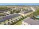 Aerial view of townhome community featuring green spaces, mature trees, and an inviting community pool at 4820 Battaglia Blvd, St Cloud, FL 34769
