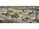 Aerial view of townhomes featuring attached garages, manicured lawns, and well-maintained roofs at 4820 Battaglia Blvd, St Cloud, FL 34769