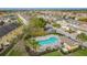 Aerial view of community pool with cabana, lounge chairs, parking, and manicured landscaping at 4820 Battaglia Blvd, St Cloud, FL 34769