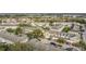 Aerial view of a residential community featuring townhomes, mature trees, and a central pool area at 4820 Battaglia Blvd, St Cloud, FL 34769