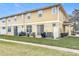 View of a cozy backyard featuring a small patio area with furniture and well-maintained lawn at 4820 Battaglia Blvd, St Cloud, FL 34769