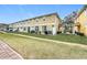 A spacious lawn of a multi-Gathering home, with a brick-paved walkway, patio, and well-kept landscaping at 4820 Battaglia Blvd, St Cloud, FL 34769