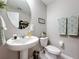 Cozy powder room with a pedestal sink and decorative accents, offering a touch of elegance at 4820 Battaglia Blvd, St Cloud, FL 34769
