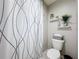 Bathroom with white shower curtain, toilet, decorations and shelfs at 4820 Battaglia Blvd, St Cloud, FL 34769