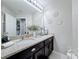 Bathroom with double sink vanity, granite counters, and decorative wall accents at 4820 Battaglia Blvd, St Cloud, FL 34769