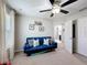 Bedroom with blue sofa, decorations, window with curtains, and ceiling fan at 4820 Battaglia Blvd, St Cloud, FL 34769