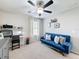 Bedroom with blue sofa, decorations, window with curtains, desk and chair at 4820 Battaglia Blvd, St Cloud, FL 34769