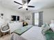 Bedroom with bed, dresser, mirror, TV and curtains at 4820 Battaglia Blvd, St Cloud, FL 34769