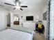 Bedroom with bed, dresser, mirror, TV and curtains at 4820 Battaglia Blvd, St Cloud, FL 34769