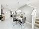 Dining area with tile flooring, a modern light fixture, and access to stairs at 4820 Battaglia Blvd, St Cloud, FL 34769